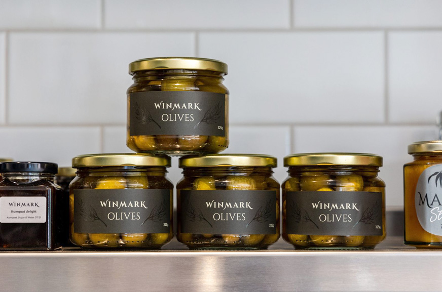 Row of Winmark Olive Jars