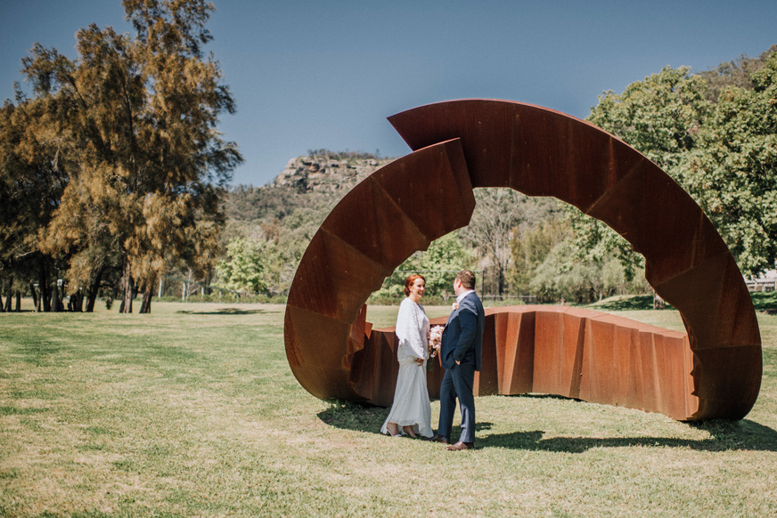 Wedding couple in front of Biosis sculpture at Winmark Wines